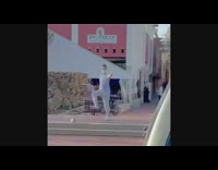 Man blue shirt dance music speakers sidewalk