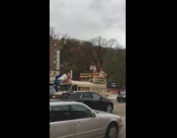 People stand and dance on brown bus 