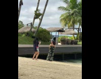 Two women poses in a different photoshoot at the beach
