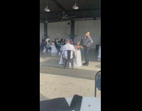 Lady carries plate of food while being filmed 