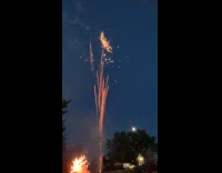 Fireworks display on night sky over street