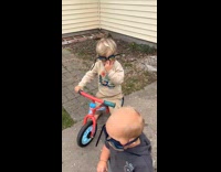 Brothers pretending swimming goggles as dirt bike goggles