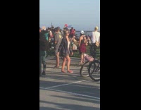 Girl peace sign by protest crowd 
