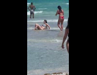 Woman in bikini lie down on the beach shore