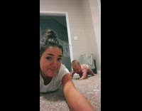 Chubby baby sits next to mom that mouths words of tiktok sound