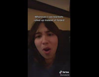 Girl reacts to picture of grey blanket