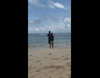 Man wears sunglasses at the beach for a video shoot