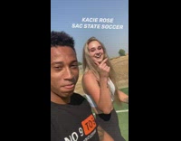 Guy races white sports bra girl grass 