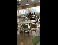 Guy spins friend red vest in blue recycling bin, trash can falls and hits the floor