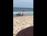 Two girls bikini play with beach water