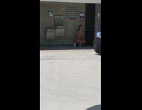 Girl bikini sit outside public toilet blue roof