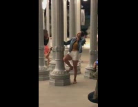 Two girls head back pose holding street lamps