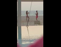 Couple dances on beach as kid watches 