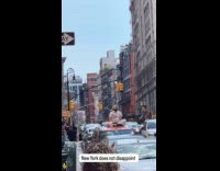 Guy meditates on car parked at street