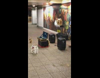 Guy plays saxophone with dancing animal dolls 