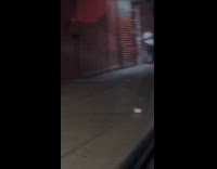 Couple having karaoke session on sidewalk