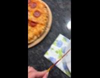 Filmer picks up thin slice of pizza
