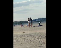 2 ladies dance for video at beach in black 