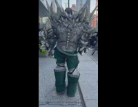 Man walks wear character costume along street at day 