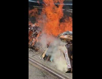 Trash cardboard boxes on fire sidewalk graffiti 