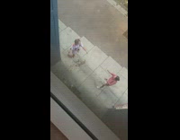 Woman spills chocolate on her and dance at the sidewalk