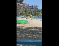 Woman green wig bikini film with son beach