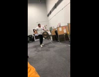 Man bangs gong all around the office