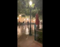 Guy running away in rain at California Adventures Disneyland