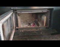 Old burnt log in fireplace make sparks