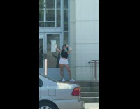 Woman black top hold face mask selfie