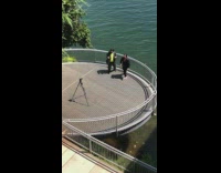 Two guys dance round platform water tripod 