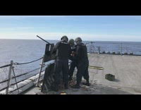 Three guys US navy shoot gun boat 