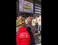 Old woman colorful costume shouts on street