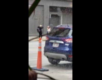 White shirt girl black car hazard lights 