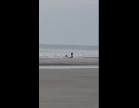 Man mermaid costume beside sword at beach