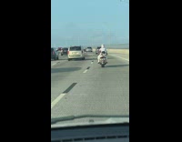 Motorcyclist drives with coke and coronas 