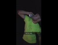 guy green shirt opens beer can with head 