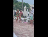 Two women in bikini sips on their drinks