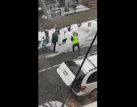 Guy poses by upright shovel in snow 
