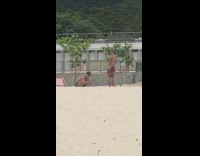 Shirtless guy tattoo colorful shorts beach cap