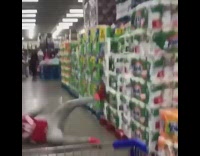 Guy jumps on stack of paper towels at a warehouse store, falls on his butt, Hollaback Girl 