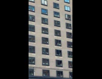 Families watches the parade from their windows 