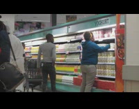 Guy tells worker at yogurt section that biscuit prices are high at grocery store