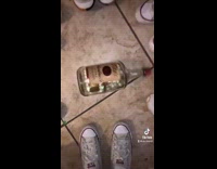 Guy spins titos bottle at fake party 