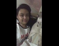 Grey white cat in bed kicks girl 