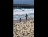 Black bikini girl lays back beach sand