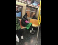 man green skirt pink boxing gloves on train