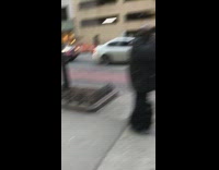 Man grey outfit ropes upside down flute