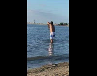 Man dance hold fish mouth selfie beach