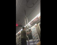 Guy rides skateboard in place in train aisle 